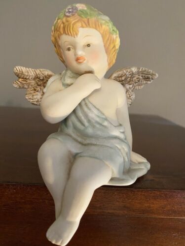 Porcelain Angel Sits On A Shelf
